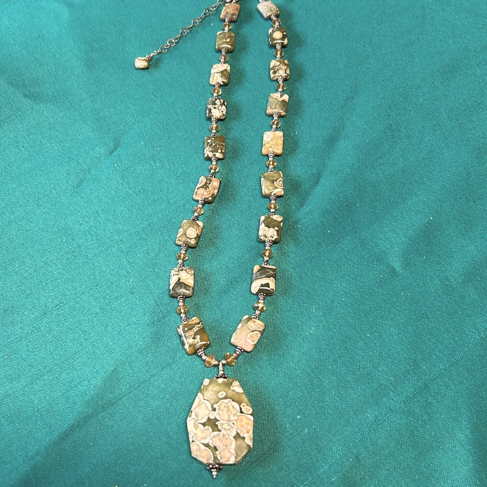Ocean fossil and yellow Swarovski crystals and sterling silver beads.